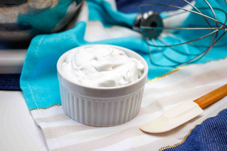 ceramic bowl with dairy free whipping cream on table 
