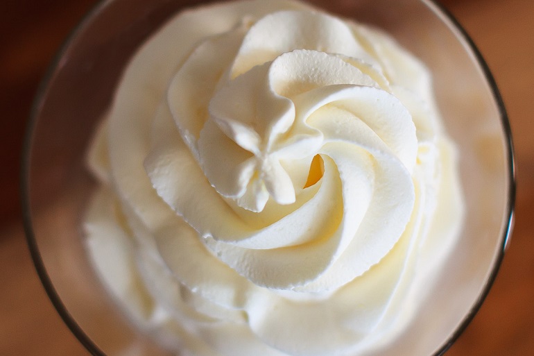 swirled dairy free whipped cream in glass 