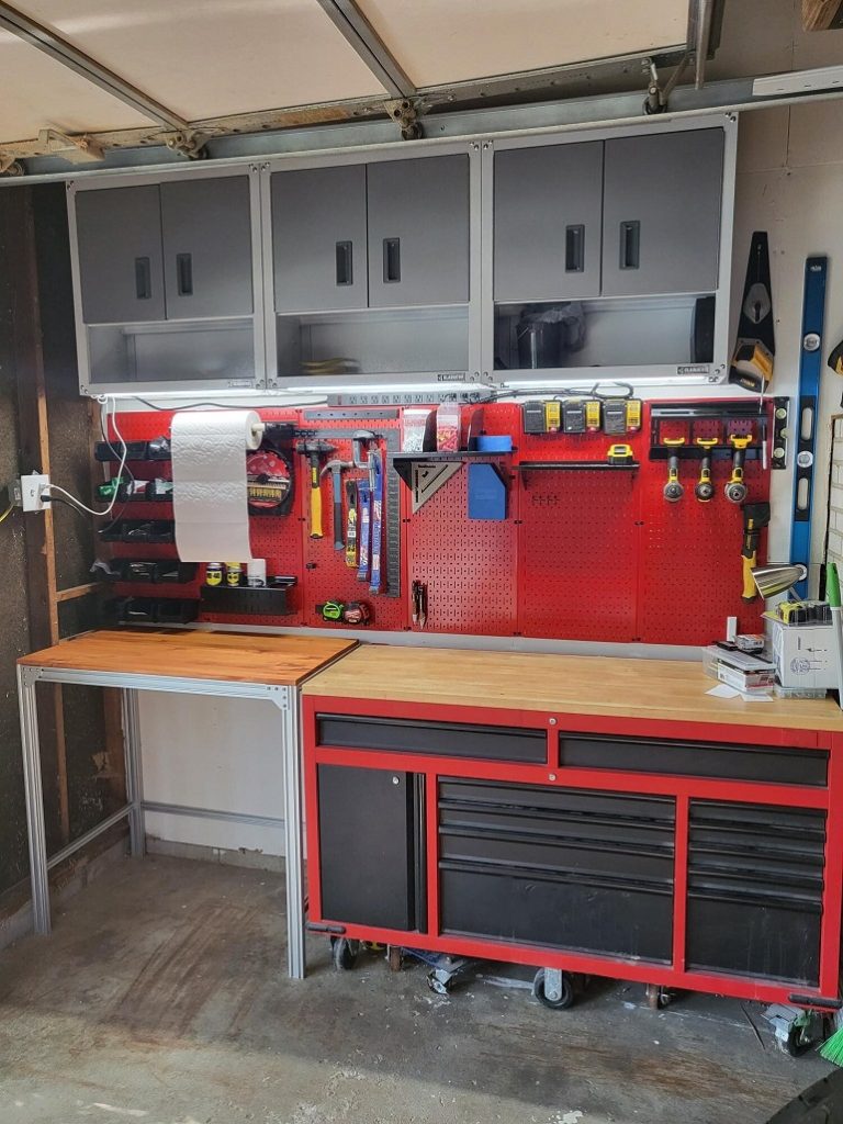 Red work bench with shelves and drawers plus work equipment