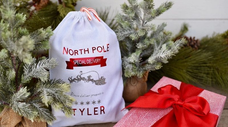 personalized Christmas sack next to Christmas tree