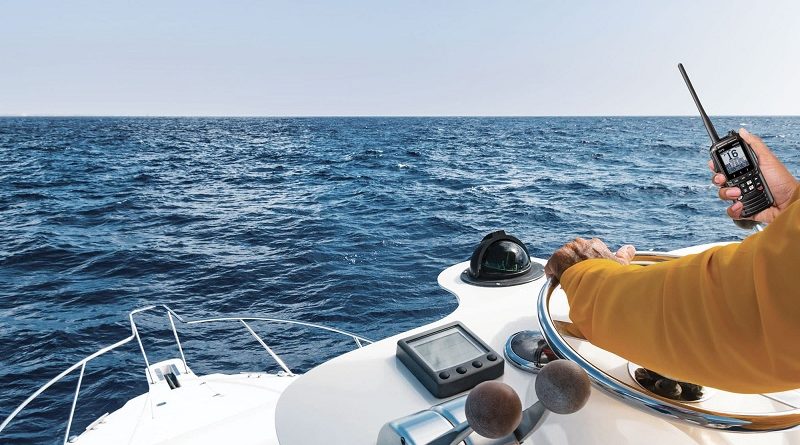 man using a VHF radio on a boat